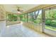 A tiled sunroom features large windows, letting in lots of natural light to enjoy beautiful views of the outdoors at 5109 28Th W St, Bradenton, FL 34207