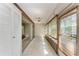 Sunroom with tile floor, wood paneled siding, and many windows and sliding glass doors at 5109 28Th W St, Bradenton, FL 34207