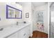 Bright bathroom features a modern vanity with white countertop, framed mirror, and access door at 5110 19Th W Ave, Bradenton, FL 34209