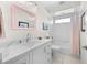 Bright bathroom featuring a pink framed mirror, white vanity, and shower/tub combination at 5110 19Th W Ave, Bradenton, FL 34209