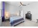 Bedroom with a ceiling fan, gray walls, a bed with striped bedding and a dark dresser at 5110 19Th W Ave, Bradenton, FL 34209