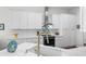 Bright kitchen featuring white cabinetry, quartz countertops, stainless steel appliances, and gold hardware at 5110 19Th W Ave, Bradenton, FL 34209
