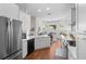 Spacious kitchen featuring white cabinets, stainless appliances, island sink, and adjacent breakfast nook at 5110 19Th W Ave, Bradenton, FL 34209