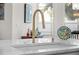 Close-up of a kitchen sink with a modern faucet and white countertop, showcasing the elegant design at 5110 19Th W Ave, Bradenton, FL 34209