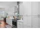 Bright kitchen with white cabinets, modern stainless appliances, marble countertops and wood flooring at 5110 19Th W Ave, Bradenton, FL 34209
