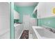 Bright laundry room with a utility sink, washer, dryer, and ample cabinet space at 5110 19Th W Ave, Bradenton, FL 34209