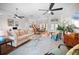 Spacious living room with hardwood floors, a large sofa, and multiple ceiling fans at 5110 19Th W Ave, Bradenton, FL 34209