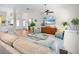 Open-concept living area featuring hardwood floors, comfortable seating, and a modern ceiling fan at 5110 19Th W Ave, Bradenton, FL 34209