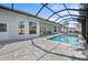 Screened-in pool area with brick pavers, lounge chairs, and an attached lanai for outdoor living at 5110 19Th W Ave, Bradenton, FL 34209