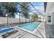 Screened-in pool features brick pavers, lawn chairs, and white privacy fence at 5110 19Th W Ave, Bradenton, FL 34209