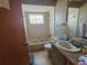 Bathroom featuring neutral tile, a shower/tub combo, and a single sink vanity at 5114 36Th Avenue W Dr, Bradenton, FL 34209
