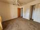 Cozy bedroom with neutral carpet, ceiling fan, and a closet at 5114 36Th Avenue W Dr, Bradenton, FL 34209