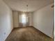 Dining room with outdated carpet and a vintage chandelier at 5114 36Th Avenue W Dr, Bradenton, FL 34209