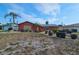 Single-story home featuring well-maintained landscaping, complemented by palm trees against a partly cloudy sky at 5114 36Th Avenue W Dr, Bradenton, FL 34209