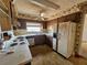 Traditional kitchen featuring older appliances, wood cabinetry, and a window over the sink at 5114 36Th Avenue W Dr, Bradenton, FL 34209