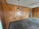 A living room featuring paneled walls, carpeting, and overhead lighting at 5114 36Th Avenue W Dr, Bradenton, FL 34209
