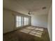 Living room with outdated carpet and a ceiling fan at 5114 36Th Avenue W Dr, Bradenton, FL 34209