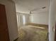 Spacious living room with outdated carpet and a ceiling fan at 5114 36Th Avenue W Dr, Bradenton, FL 34209