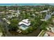 A luxury waterfront home featuring a pool, private dock and lush tropical landscaping at 512 Treasure Boat Way, Sarasota, FL 34242