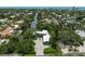 Aerial view of waterfront home surrounded by lush trees and beautiful blue canals at 512 Treasure Boat Way, Sarasota, FL 34242