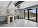 Stylish bar area with sleek countertops, open shelving, a wine fridge, and access to an outdoor patio at 512 Treasure Boat Way, Sarasota, FL 34242