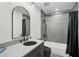 Sleek bathroom with modern fixtures, a dark vanity, a shower-tub combination, and stylish black hardware at 512 Treasure Boat Way, Sarasota, FL 34242
