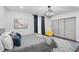 Modern bedroom features sleek gray walls, art, stylish chandelier, and plush gray bedding with an accent rug at 512 Treasure Boat Way, Sarasota, FL 34242