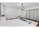 Bright bedroom with hardwood floors, soft rug, and slider closet doors at 512 Treasure Boat Way, Sarasota, FL 34242