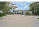 Expansive brick driveway leads to a contemporary stucco home with mature landscaping at 512 Treasure Boat Way, Sarasota, FL 34242