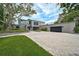Contemporary home featuring a large driveway, manicured landscaping, and an attached two-car garage at 512 Treasure Boat Way, Sarasota, FL 34242