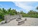 Charming backyard fire pit area with stone seating, perfect for cozy evenings outdoors at 512 Treasure Boat Way, Sarasota, FL 34242