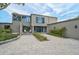 Contemporary home with lush landscaping and an inviting front entrance with comfortable outdoor seating at 512 Treasure Boat Way, Sarasota, FL 34242