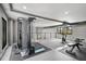Well-equipped home gym featuring various workout stations, bright windows, and an open, airy atmosphere at 512 Treasure Boat Way, Sarasota, FL 34242