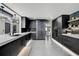 Contemporary kitchen with stainless steel refrigerator, dark cabinets and pendant lighting at 512 Treasure Boat Way, Sarasota, FL 34242