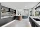 Modern kitchen with dark cabinetry, light countertops, open shelving, and stainless steel appliances at 512 Treasure Boat Way, Sarasota, FL 34242