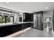 Modern kitchen with dark cabinets, stainless appliances, and a seamless transition to the living area at 512 Treasure Boat Way, Sarasota, FL 34242