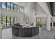 Elegant living room featuring a modern fireplace, high ceilings, large windows, and comfortable seating at 512 Treasure Boat Way, Sarasota, FL 34242