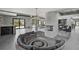 Open-concept living area with sunken circular sofas, fireplace, and sleek design at 512 Treasure Boat Way, Sarasota, FL 34242