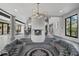 Expansive living area featuring a distinctive fireplace and stylish circular sofas at 512 Treasure Boat Way, Sarasota, FL 34242
