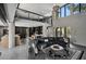 Bright living room showcasing a circular sofa, high ceilings, a balcony, and seamless flow to the kitchen at 512 Treasure Boat Way, Sarasota, FL 34242