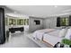 Spacious main bedroom with large windows, desk area, and modern gray color palette at 512 Treasure Boat Way, Sarasota, FL 34242