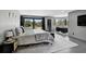 Luxurious main bedroom with pool view, desk area, and sleek modern finishes at 512 Treasure Boat Way, Sarasota, FL 34242