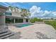 Stunning backyard pool with stone patio and custom seating, a perfect place to entertain and relax at 512 Treasure Boat Way, Sarasota, FL 34242