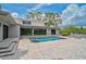 Beautiful backyard pool and modern home with large glass doors, merging indoor-outdoor living at 512 Treasure Boat Way, Sarasota, FL 34242