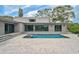 Modern home showcases an inviting backyard pool and expansive patio, perfect for relaxation and entertaining at 512 Treasure Boat Way, Sarasota, FL 34242