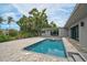 Inviting pool and patio area of a modern home, ideal for outdoor relaxation and entertaining guests at 512 Treasure Boat Way, Sarasota, FL 34242