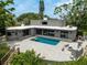 Beautiful backyard featuring a sparkling swimming pool, paved patio, and an outdoor fire pit for entertaining at 512 Treasure Boat Way, Sarasota, FL 34242