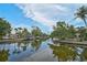 Picturesque waterfront view with boat docks and lush landscaping, providing serene scenery at 512 Treasure Boat Way, Sarasota, FL 34242