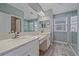 Bright bathroom with double vanity, modern fixtures, and glass-enclosed shower at 5191 78Th St E Cir, Bradenton, FL 34203