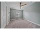 Bedroom featuring plush carpet, ceiling fan, and a window at 5191 78Th St E Cir, Bradenton, FL 34203